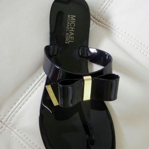 Black Michael Kors bow flip flops